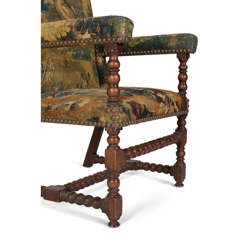 46 - A WALNUT AND VERDURE TAPESTRY UPHOLSTERED ARMCHAIR 18TH CENTURYWith bobbin turned supports throughou... 