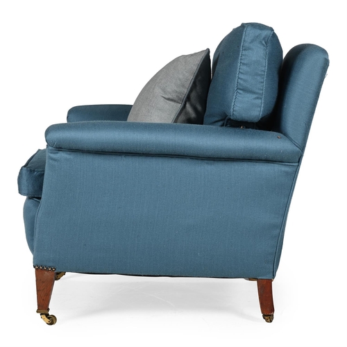 573 - A MAHOGANY AND BLUE UPHOLSTERED ARMCHAIR IN THE MANNER OF HOWARD & SONS, EARLY 20TH CENTURYOn square... 