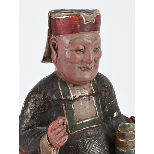 311 - A CHINESE CARVED AND POLYCHROME PAINTED FIGURE OF A SEATED OFFICIAL18TH OR 19TH CENTURY41cm high, 20... 