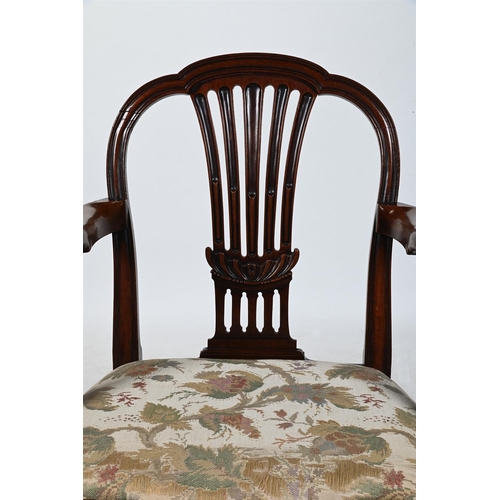 384 - A GEORGE III MAHOGANY OPEN ARMCHAIR, IN THE MANNER OF GEORGE HEPPLEWHITECIRCA 1800 With vertical spl... 