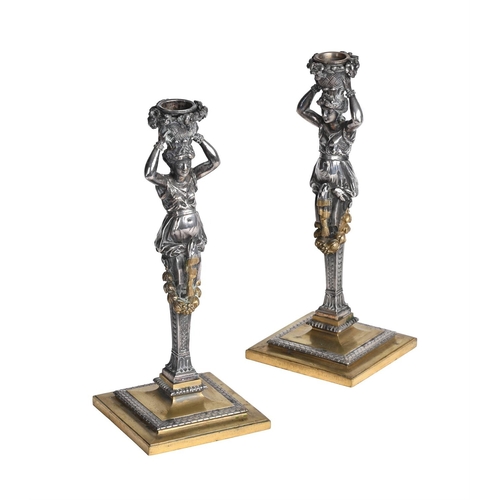 385 - A PAIR OF FRENCH SILVERED AND GILT BRASS CANDLESTICKS MID 19TH CENTURYEach formed as standing herm f... 