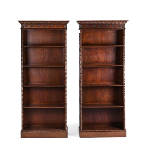 431 - A PAIR OF WALNUT OPEN BOOKCASES OF RECENT MANUFACTURE With Vitruvian scrolls to the cornice, the tap... 