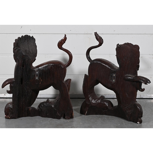 624 - A PAIR OF CARVED WOOD WALL MOUNTED TEMPLE GUARDIANS 20TH CENTURY Modelled opposingeach approximately... 