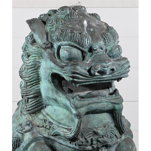 646 - A VERY LARGE PAIR OF PATINATED METAL GARDEN MODELS OF CHINESE GUARDIAN LIONS OR FOO DOGS20TH CENTURY... 