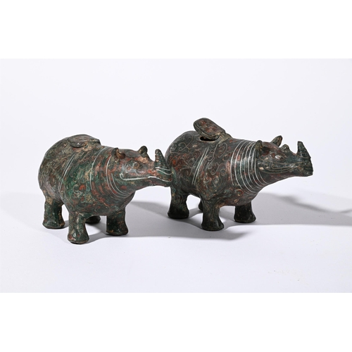 690 - A PAIR OF CHINESE ARCHAISTIC MODELS OF RHINOS20TH CENTURYInlaid with wire, hinged covers to backs fo... 