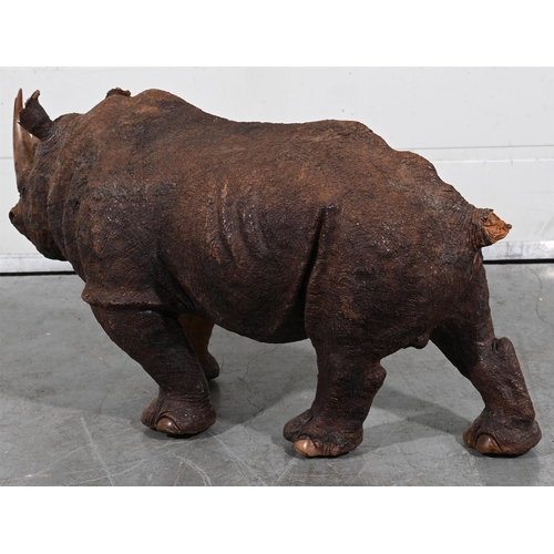 701 - A CARVED WOODEN SCULPTURE OF A RHINO43cm high, 91cm long, 33cm wideProvenance:Private Collection