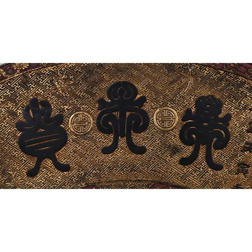 704 - A CHINESE CARVED AND POLYCHROME PAINTED WOODEN GOLD LEAF PANEL20TH CENTURYDepicted as a scroll with ... 