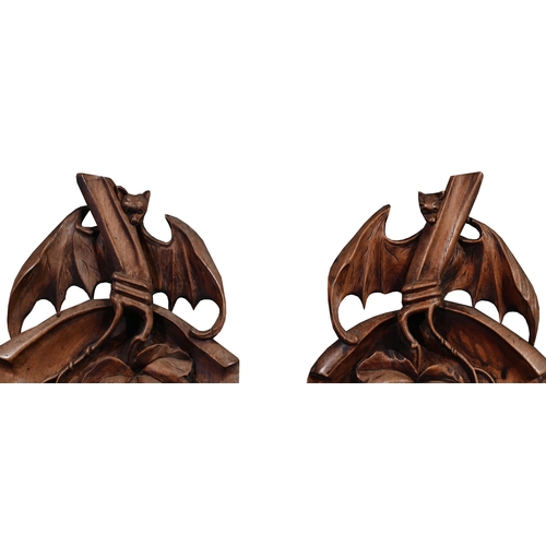 705 - A PAIR OF CARVED WOODEN CHINESE TEAK PANELS WITH BATS AND FRUIT20TH CENTURY114cm high, 21cm wide, 4c... 