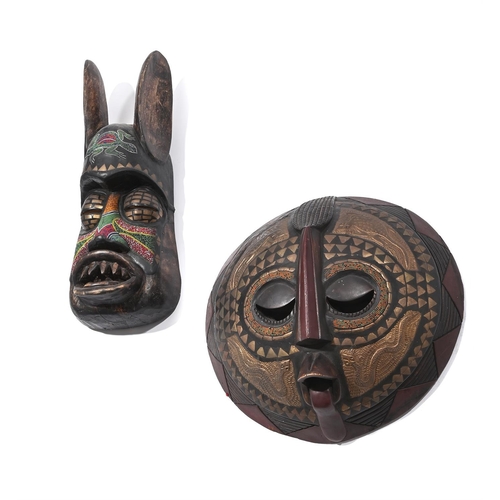 723 - TWO AFRICAN CARVED WOOD, PAINTED AND BEADED MASKS 20TH CENTURYDecorated with colourful beads and oth... 