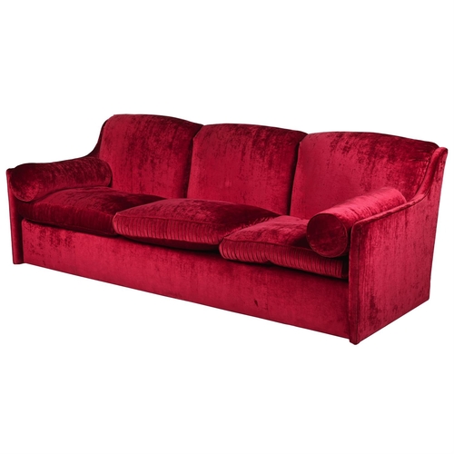 111 - A RED VELVET THREE SEAT SOFABY LUCY EADIE INTERIORS, OF RECENT MANUFACTURE88cm high, 244cm wide, 95c... 