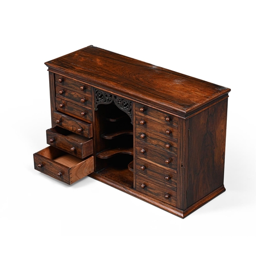 129 - Y AN UNUSUAL REGENCY ROSEWOOD DOUBLE WELLINGTON CHEST OR TABLE CABINETCIRCA 1820With a shelved and m... 