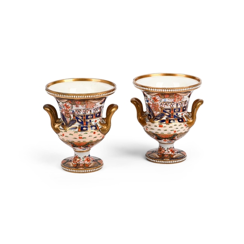 159 - A PAIR OF SPODE CAMPANA URNSCIRCA 1810Painted in the Imari manner with a fenced garden, iron-red fac... 