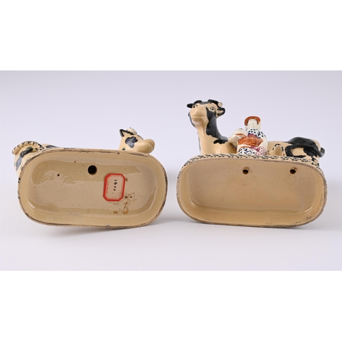 162 - TWO BUFF-COLOURED POTTERY COW AND CALF GROUPS OF YORKSHIRE TYPECIRCA 1820One modelled with a milkmai... 