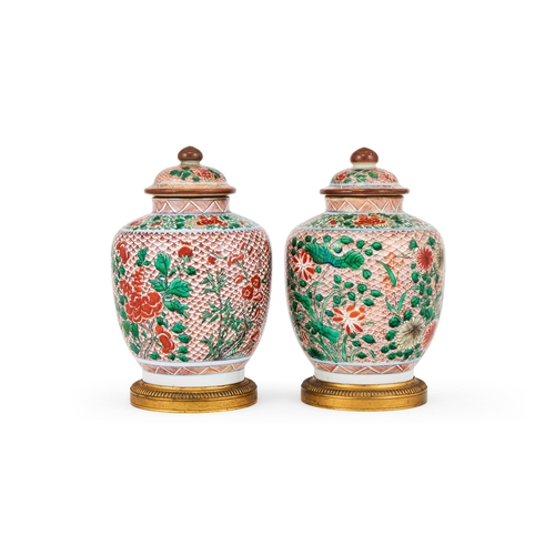 173 - A PAIR OF CHINESE WUCAI SMALL JARS AND COVERS20TH CENTURYWith ormolu mounts, each decorated in green... 