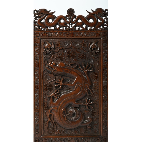 174 - A CHINESE OR SOUTH EAST ASIAN HARDWOOD CARVED THREE-FOLD 'DRAGON' SCREENLATE QING DYNASTYWith shou s... 