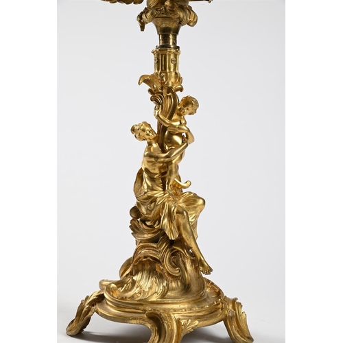 53 - AN ORMOLU SIX-LIGHT CENTERPEIECE CANDELABRUM IN ROCOCO STYLE, 1860-1880Previously wired72cm high, ba... 