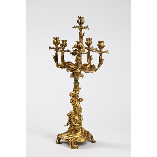 53 - AN ORMOLU SIX-LIGHT CENTERPEIECE CANDELABRUM IN ROCOCO STYLE, 1860-1880Previously wired72cm high, ba... 