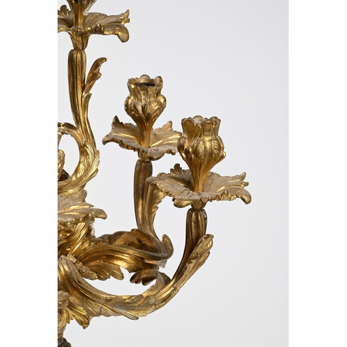 53 - AN ORMOLU SIX-LIGHT CENTERPEIECE CANDELABRUM IN ROCOCO STYLE, 1860-1880Previously wired72cm high, ba... 