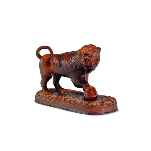 111 - A TREACLE-GLAZED POTTERY MODEL OF A MEDICI LIONENGLISH, MID 19TH CENTURY27cm high, 40cm wide