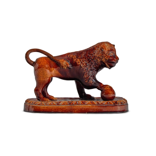 111 - A TREACLE-GLAZED POTTERY MODEL OF A MEDICI LIONENGLISH, MID 19TH CENTURY27cm high, 40cm wide