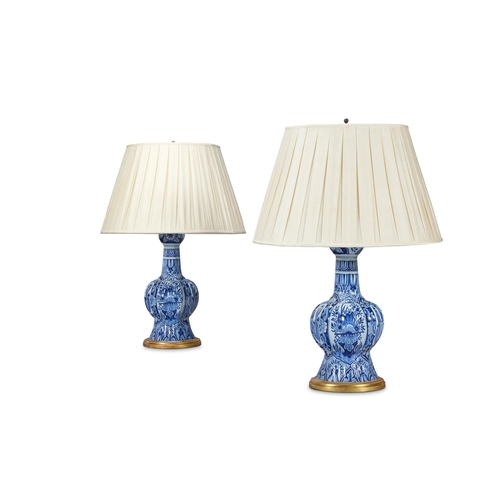 134 - A PAIR OF BLUE AND WHITE DELFT VASES DUTCH, 19TH CENTURYNow mounted and wired as lamps90cm high over... 