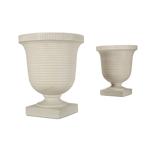 148 - A PAIR OF WHITE PAINTED COMPOSITION STONE RIBBED URNS OF LARGE SIZEMODERNOn white patinated wooden p... 