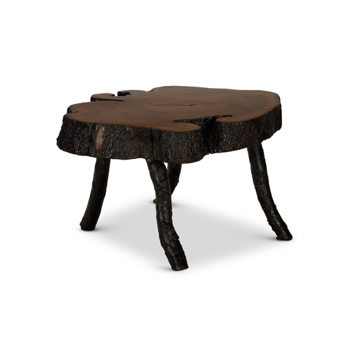 153 - A HARDWOOD LOW TABLE OF LARGE SIZE20TH CENTURYMade from a cross section of a tree-trunk on four rust... 