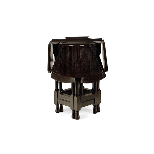 157 - AN ARTS AND CRAFTS EBONISED OAK DROP-LEAF GATELEG TABLE EARLY 20TH CENTURY The circular top comprisi... 