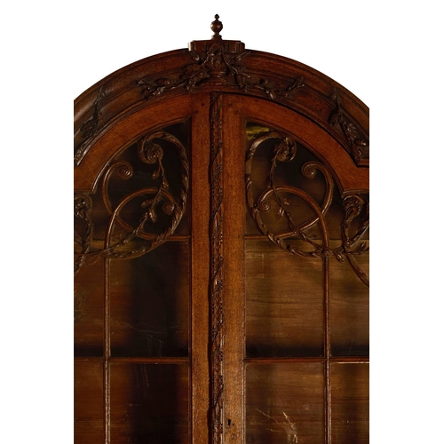 16 - AN OAK DISPLAY CABINETDUTCH, LATE 18TH/EARLY 19TH CENTURYThe arched top surmounted by an urn draped ... 