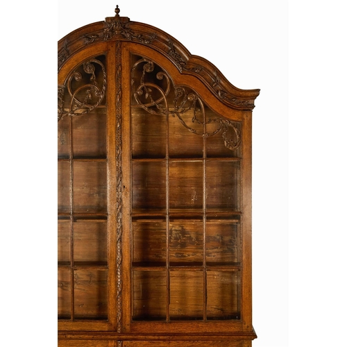 16 - AN OAK DISPLAY CABINETDUTCH, LATE 18TH/EARLY 19TH CENTURYThe arched top surmounted by an urn draped ... 