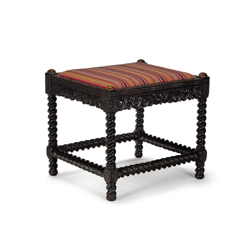 2 - Y A CARVED EBONY STOOL CEYLONESE, SECOND HALF 19TH CENTURY With striped cotton upholstered drop in s... 