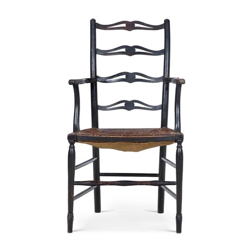 230C - AN ARTS AND CRAFTS STAINED BEECH PIERCED LADDERBACK ARMCHAIR   LATE 19TH CENTURY       With stylised... 