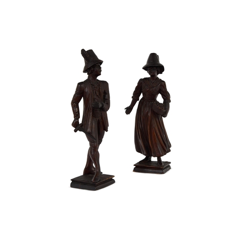 243 - A PAIR OF CARVED PINE FIGURES OF A GENTLEMAN AND LADY NORTH EUROPEAN, 19TH CENTURY36cm high