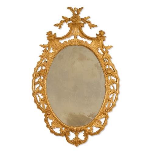 286 - A GILTWOOD MIRROR  20TH CENTURY, IN THE GEORGE III STYLE  The oval plate within a pierced rockwork, ... 