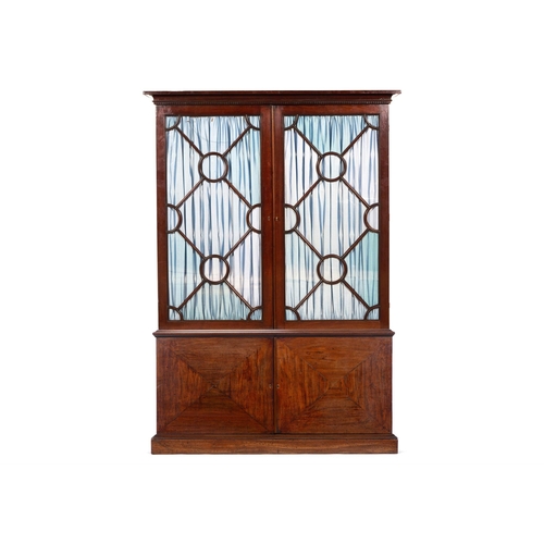 30 - A GEORGE III MAHOGANY BOOKCASE18TH CENTURY AND LATER With two replaced glazed doors hung with fabric... 