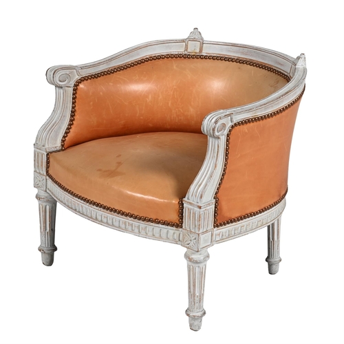 163 - A WHITE PAINTED AND LEATHER UPHOLSTERED BOUDOIR CHAIR IN LOUIS XVI STYLE, LATE 19TH OR EARLY 20TH CE... 