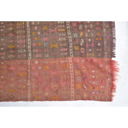 23 - A FLATWOVEN RUG OR WALL-HANGING possibly kilim, constructed of five woven strips in different colour... 