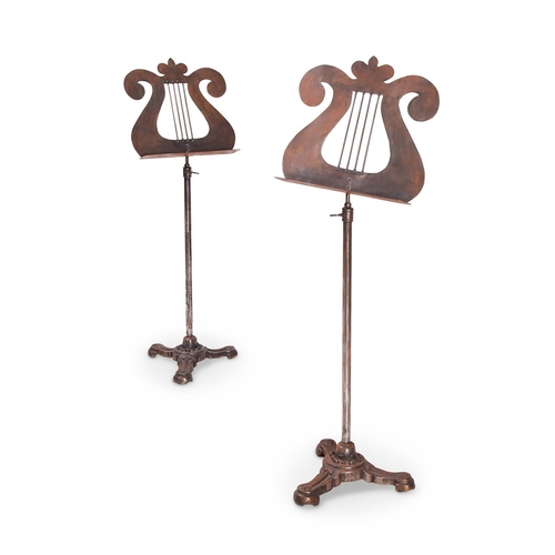 235 - A PAIR OF STEEL AND CAST IRON MUSIC STANDSSECOND HALF 19TH CENTURY AND LATER The triform bases secon... 