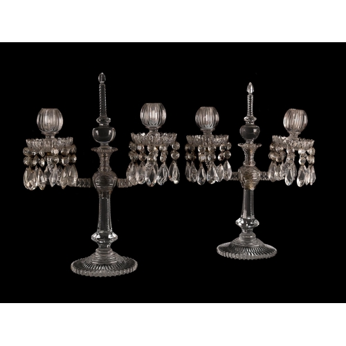 239 - A PAIR OF TWO-LIGHT CUT GLASS TABLE LUSTRES MID 19TH CENTURY Each with an upright finial and flanked... 