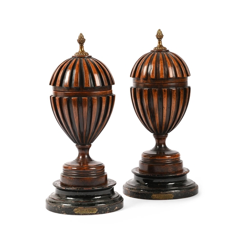 44 - A PAIR OF MAHOGANY URNS IN GEORGE III STYLE, 20TH CENTURYOf domed form, with removable lids42cm high