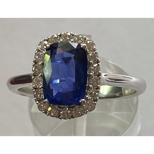 103 - AN 18CT WHITE GOLD CUSHION CUT CEYLON SAPPHIRE AND DIAMOND CLUSTER RING, with central sapphire stone... 