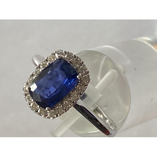 103 - AN 18CT WHITE GOLD CUSHION CUT CEYLON SAPPHIRE AND DIAMOND CLUSTER RING, with central sapphire stone... 