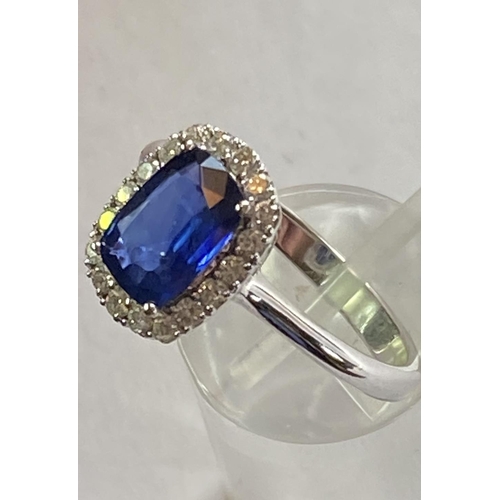 103 - AN 18CT WHITE GOLD CUSHION CUT CEYLON SAPPHIRE AND DIAMOND CLUSTER RING, with central sapphire stone... 