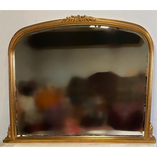 108 - A GOOD QUALITY GILT OVER-MANTLE / HALL MIRROR, with curved top, having a central foliage decoration,... 