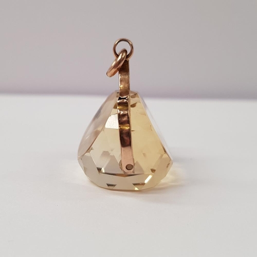 113 - A 9CT ROSE GOLD CITRINE SPINNER FOB PENDANT, with engraved floral detail to the rose gold swing pend... 