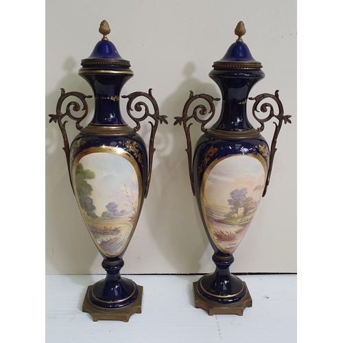 128 - A RARE PAIR OF 19TH CENTURY PORCELAIN LIDDED URNS, with hand painted imagery, and ormolu mounts, in ... 