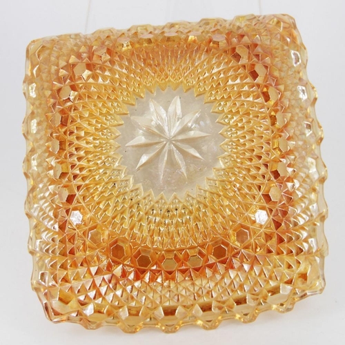 138 - AN EARLY 20TH CENTURY CARNIVAL GLASS BOWL, in orange/camber colour, square in shape, 23cm across app... 