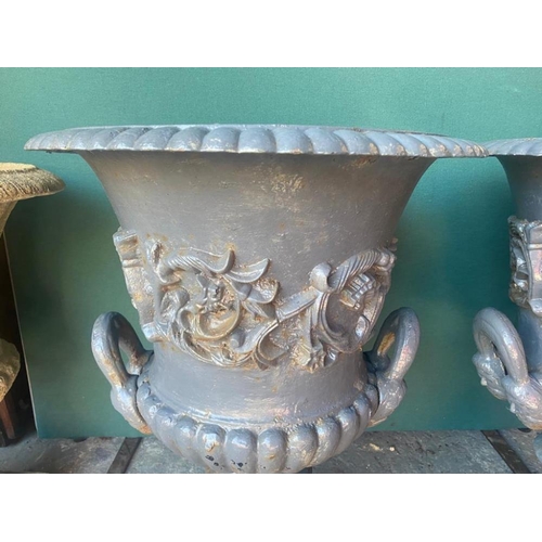 146 - A PAIR OF IRISH 19TH CENTURY HEAVY CAST IRON GARDEN URNS ON PLINTHS, urns decorated with turn over g... 