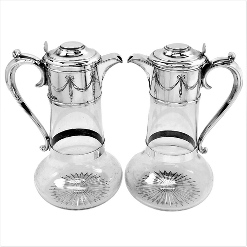 17 - A FINE PAIR OF LATE 19TH CENTURY SILVER & GLASS CLARET JUGS, London, 1891/1892, by Horace Woodward a... 