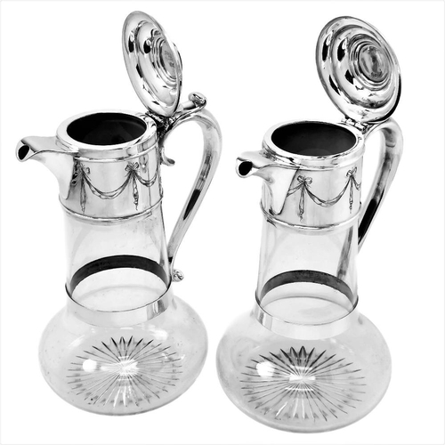 17 - A FINE PAIR OF LATE 19TH CENTURY SILVER & GLASS CLARET JUGS, London, 1891/1892, by Horace Woodward a... 